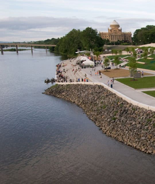 view of a river and trail with architecture