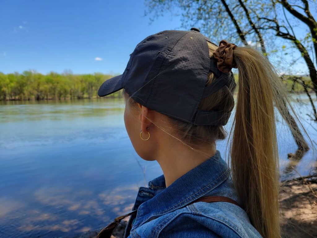 girl wearing hat with ponytail