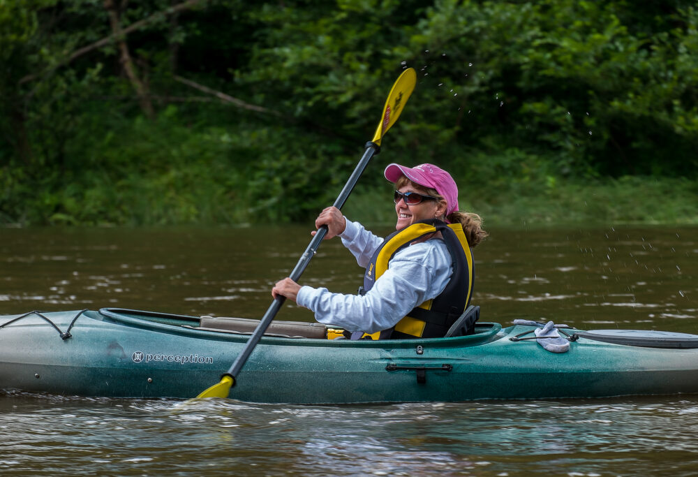 A paddler mid-stroke enjoys traveling down the Susquehanna River.