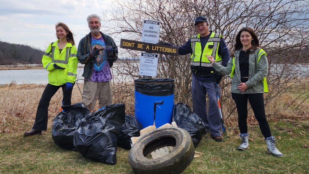volunteers pose with collected trask