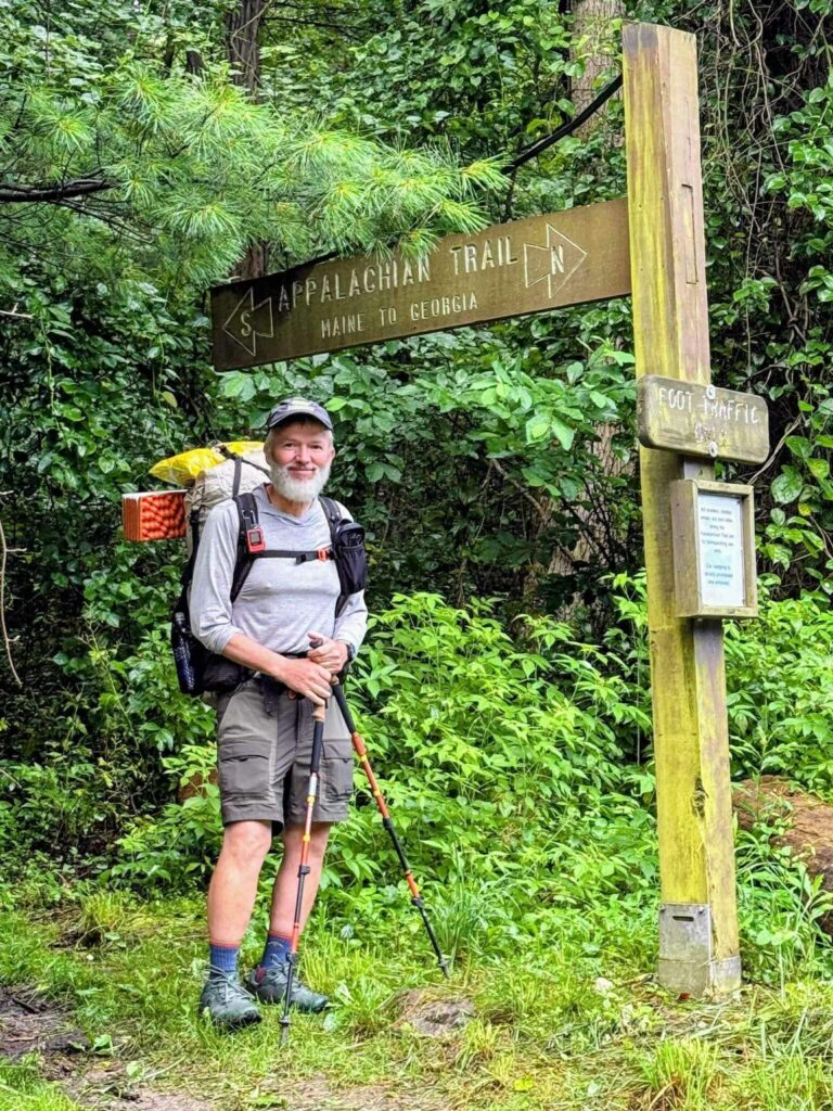 Man standing at a trailhead for the Appalachian Trail